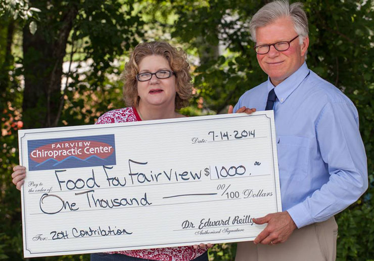 Dr. Reilly presenting a check to Executive Director Cassia Imholz, Food for Fairview.